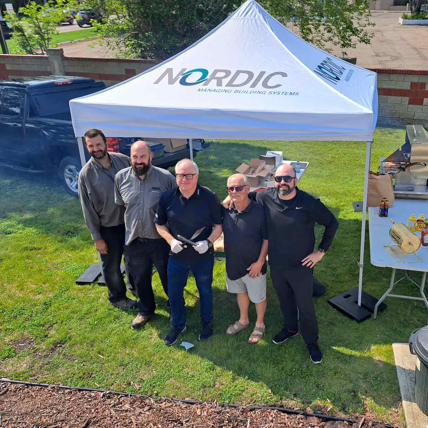 picture of 5 men under a nordic sponsored tent