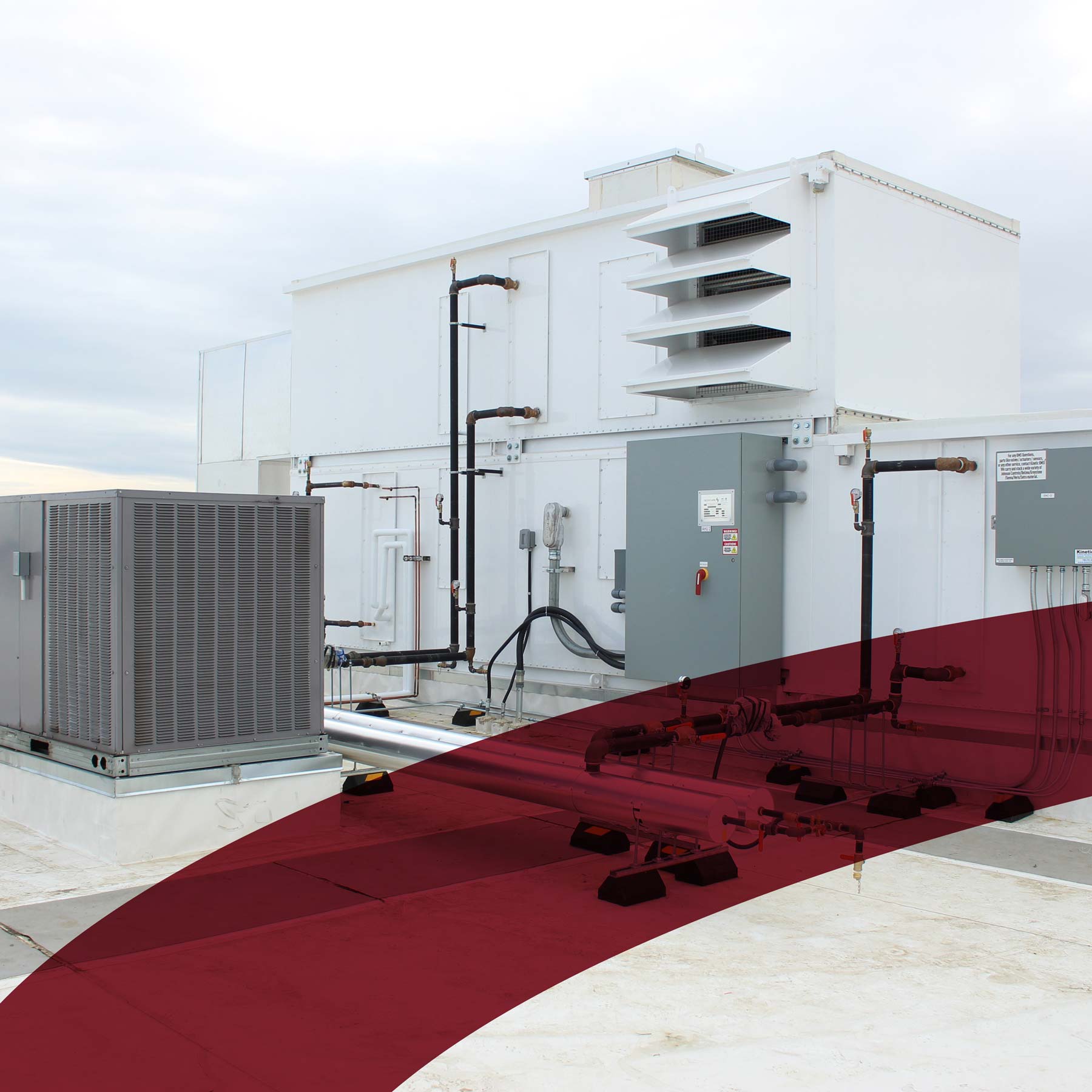 rooftop commercial unit with red branding mark